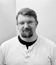 A black-and-white photograph of an average-looking white man. 