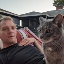 Sam Lohmann with cat in hammock